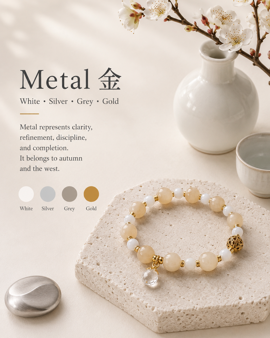 Metal element palette — a honey jade and white agate bracelet on a stone tile beside a white ceramic vase with plum blossoms.